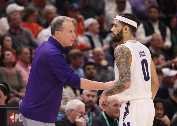 Northwestern coach Chris Collins talks with guard Boo Buie during overtime of a Big Ten Tournament quarterfinal against Penn State on March 10, 2023, at the United Center. (John J. Kim/Chicago Tribune)