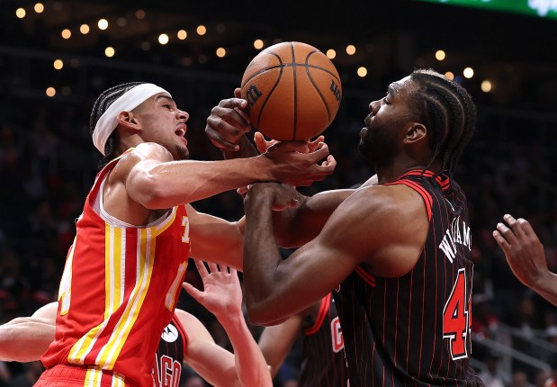 Bulls forward Patrick Williams, right, strips the ball from the Hawks' Asa Newell during the first quarter Tuesday, Dec. 23, 2025, in Atlanta. (Kevin C. Cox/Getty Images)