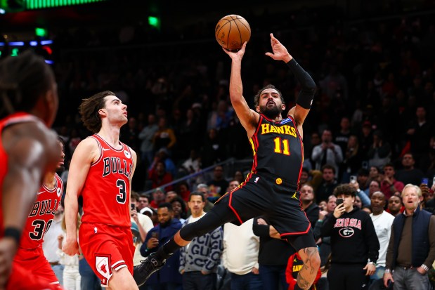 Atlanta Hawks guard Trae Young misses a game-tying shot as time expires against Chicago Bulls guard Josh Giddey during the second half on Sunday, Dec. 21, 2025, in Atlanta. (AP Photo/Colin Hubbard)