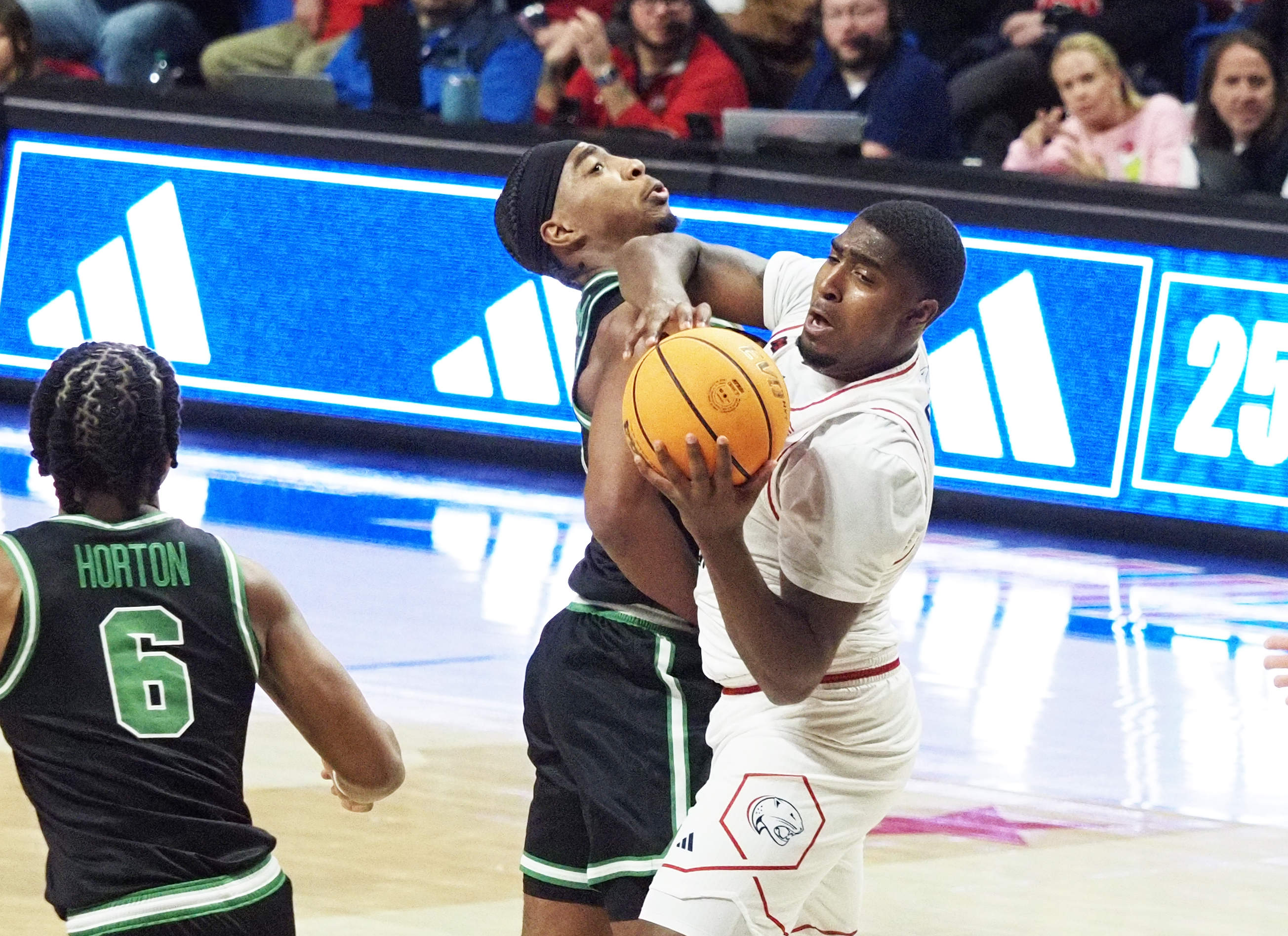 South Alabama guard Randy Brady battles for the ball with North Texas guard Je'Shawn Stevenson in the first half of a NCAA basketball game Sunday, Dec. 14, 2025, at the Mitchell Center in Mobile, Ala. (Mike Kittrell/AL.com) 