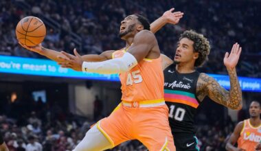 Cleveland Cavaliers guard Donovan Mitchell (45) drives to the basket past San Antonio Spurs forward Jeremy Sochan (10) in the first half of an NBA basketball game Friday, Dec. 5, 2025, in Cleveland.