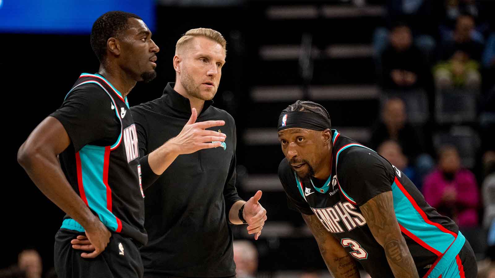 Memphis Grizzlies head coach Tuomas Iisalo talks to guard Vince Williams Jr. (5) and forward Cedric Coward (23) during a timeout in the first half against the Utah Jazz at FedExForum.