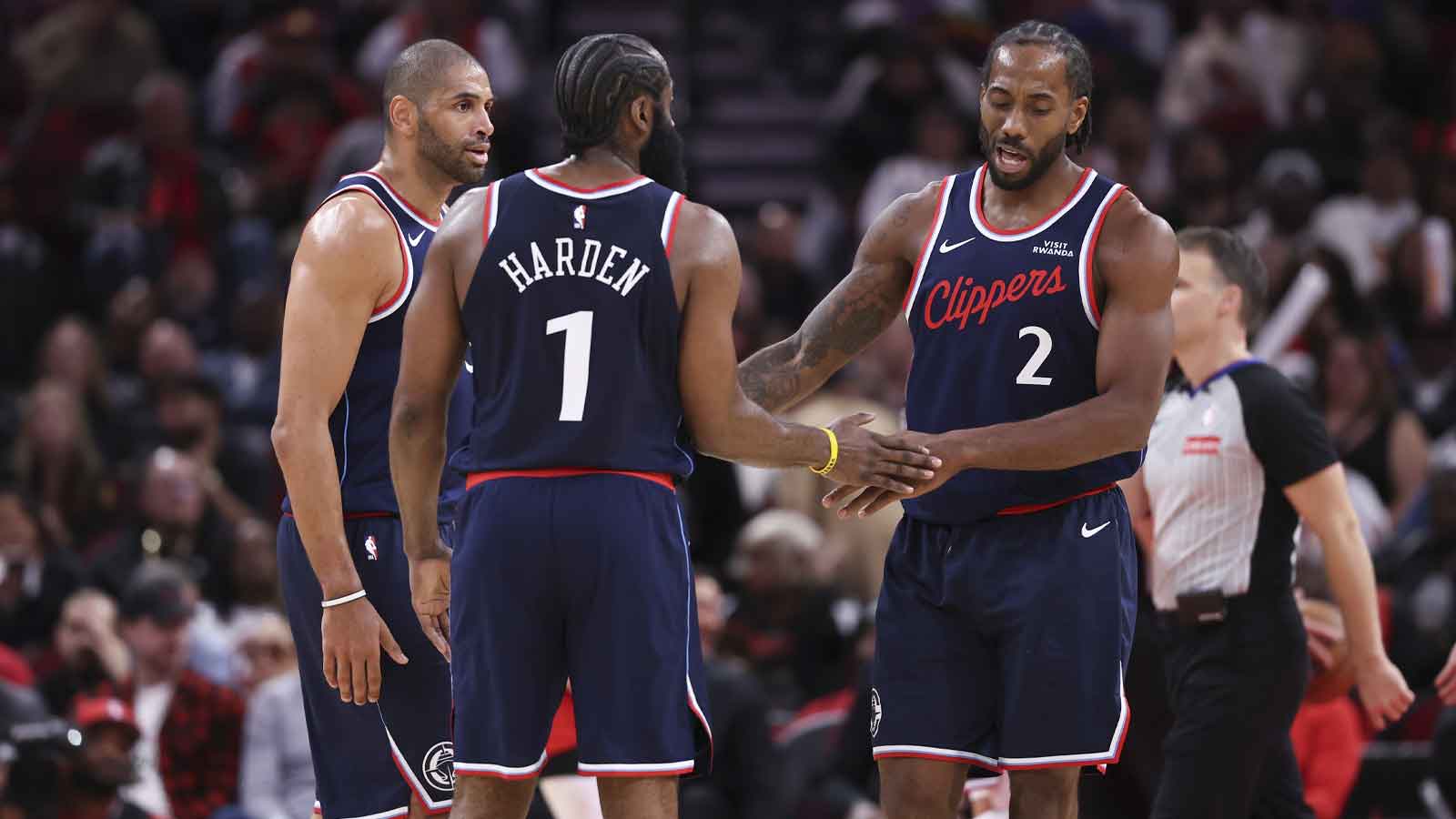 Los Angeles Clippers forward Kawhi Leonard (2) reacts with guard James Harden (1) and forward Nicolas Batum (33) after a play during the fourth quarter against the Houston Rockets at Toyota Center.