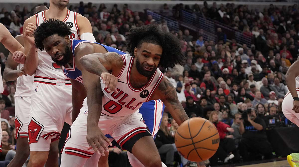 Philadelphia 76ers center Joel Embiid (21)and Chicago Bulls guard Coby White (0) go for the ball during the second half at United Center. 