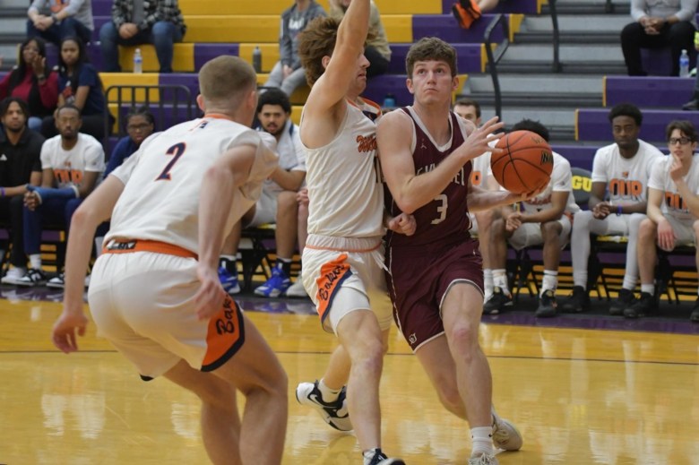 Garrett Davault , wearing an Evangel Valor basketball uniform, drives toward the basket during an NAIA Tournament game.