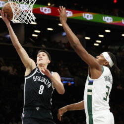 Brooklyn Nets guard Egor Demin (8) goes to the basket past Milwaukee Bucks center Myles Turner (3) during the first half of an NBA basketball game, Sunday, Dec. 14, 2025, in New York. (AP Photo/Heather Khalifa)
