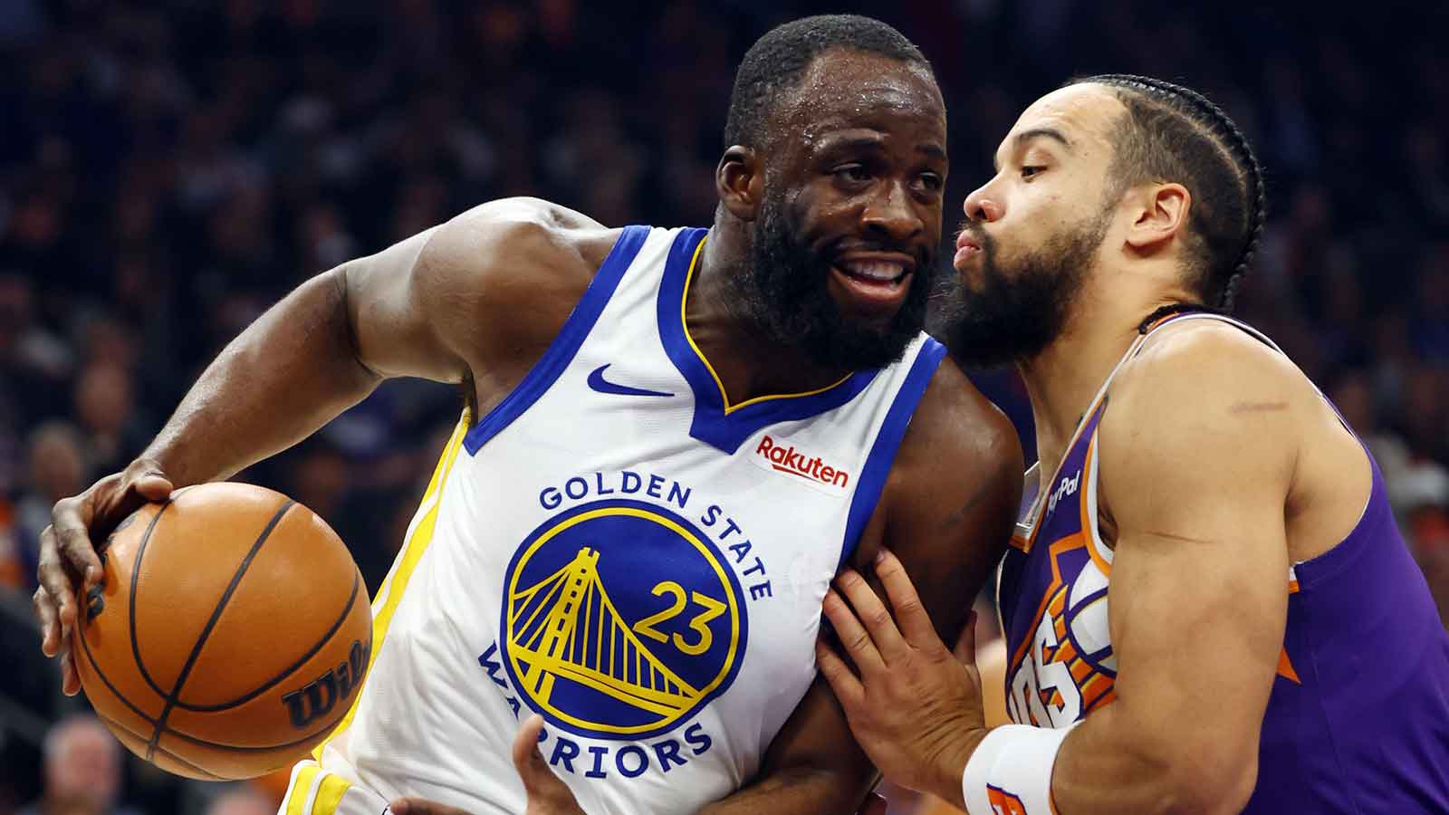 Golden State Warriors forward Draymond Green (23) against Phoenix Suns forward Dillon Brooks in the first half at Mortgage Matchup Center. 