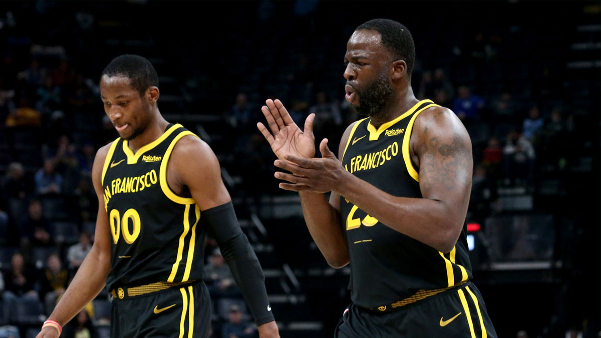 Golden State Warriors forward Jonathan Kuminga (00) and Golden State Warriors forward Draymond Green (23) walk to the bench at the end of the first quarter against the Memphis Grizzlies at FedExForum.