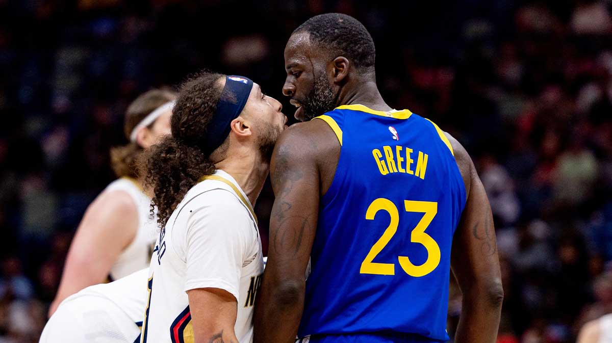 New Orleans Pelicans guard Jose Alvarado (15) and Golden State Warriors forward Draymond Green (23) after a play during the first half at Smoothie King Center.