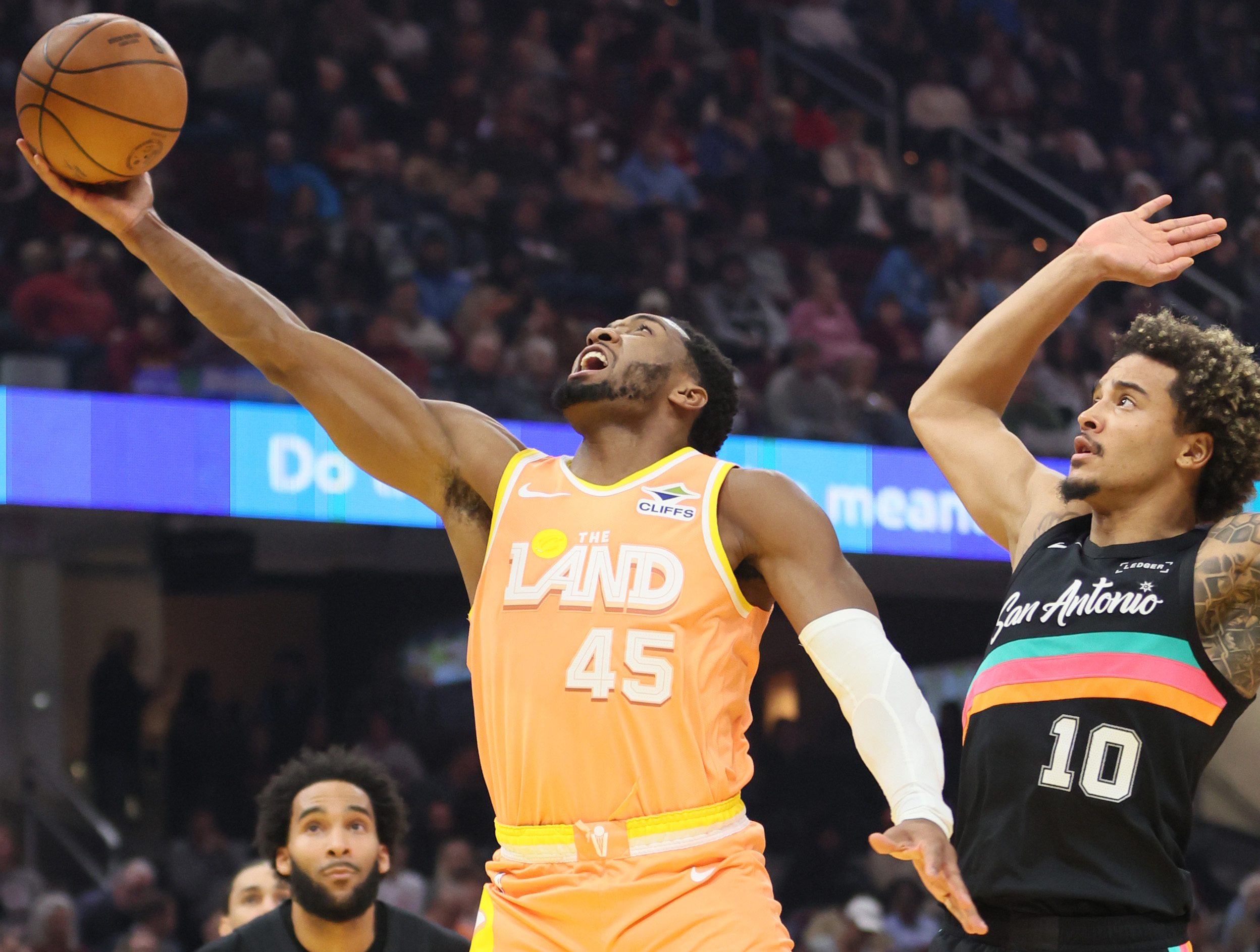 Cleveland Cavaliers guard Donovan Mitchell lays the ball u for a score guarded by San Antonio Spurs forward Jeremy Sochan in the first half at Rocket Arena. 