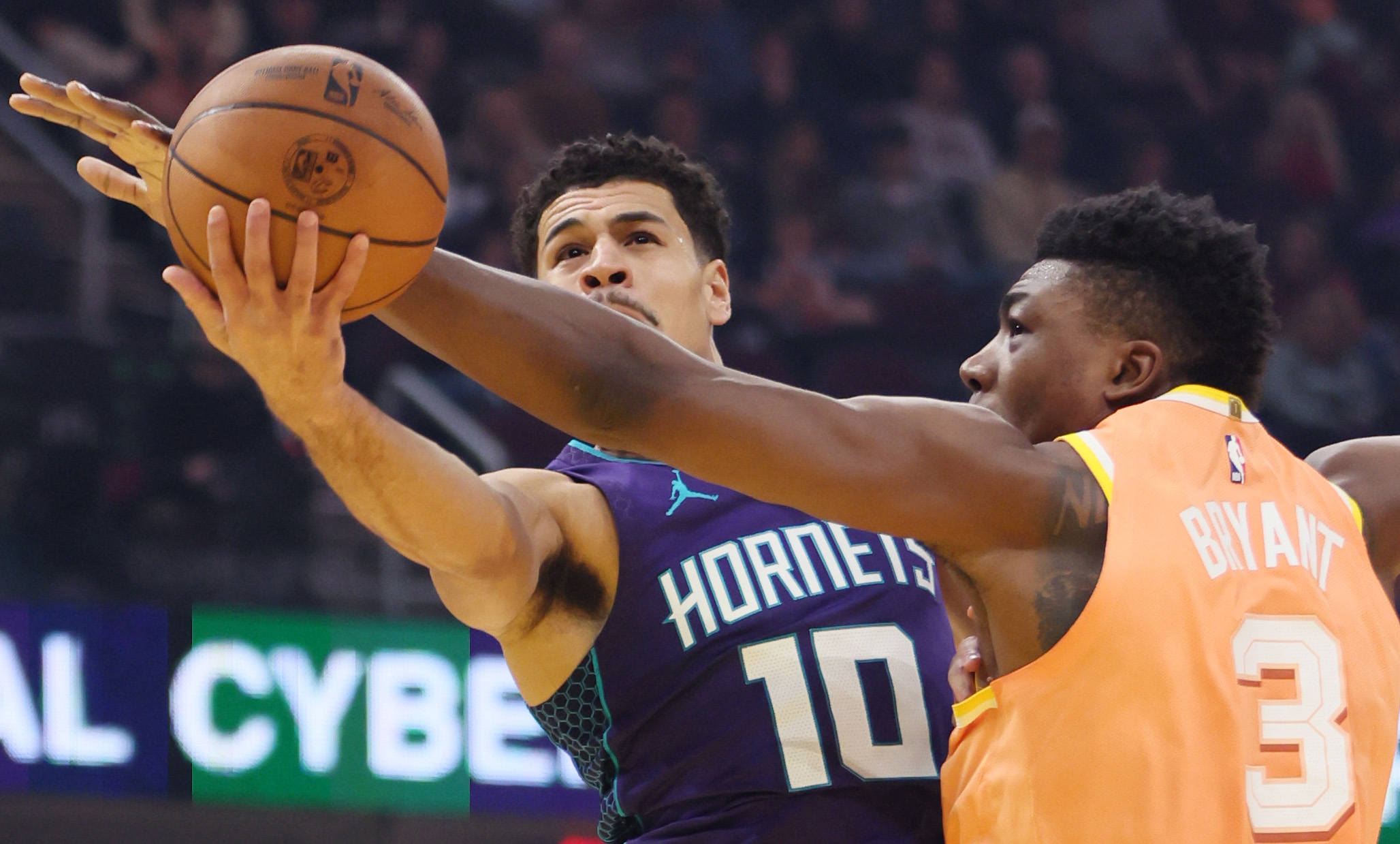 Charlotte Hornets guard Josh Green tries to lay the basketball up for a shot as he is filed by Cleveland Cavaliers center Thomas Bryant in the first half at Rocket Arena. 