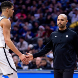 Brooklyn Nets head coach Jordi Fernandez, right, low fives Michael Porter Jr., left, after time is called during the second half of an NBA basketball game against the Philadelphia 76ers, Tuesday, Dec. 23, 2025, in Philadelphia. (AP Photo/Chris Szagola)