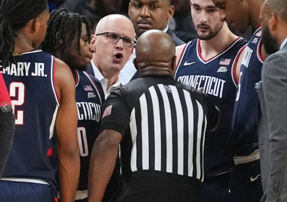UConn head coach Dan Hurley, third from left, talks to a referee during the first half of an...