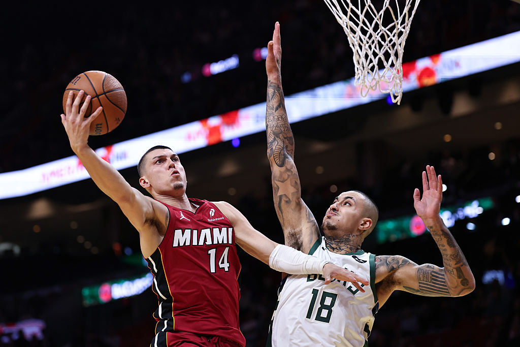 MIAMI, FLORIDA - NOVEMBER 26: Tyler Herro #14 of the Miami Heat drives to the net around Kyle Kuzma #18 of the Milwaukee Bucks during the first half at Kaseya Center on November 26, 2025 in Miami, Florida. NOTE TO USER: User expressly acknowledges and agrees that, by downloading and or using this photograph, User is consenting to the terms and conditions of the Getty Images License Agreement. (Photo by Carmen Mandato/Getty Images)