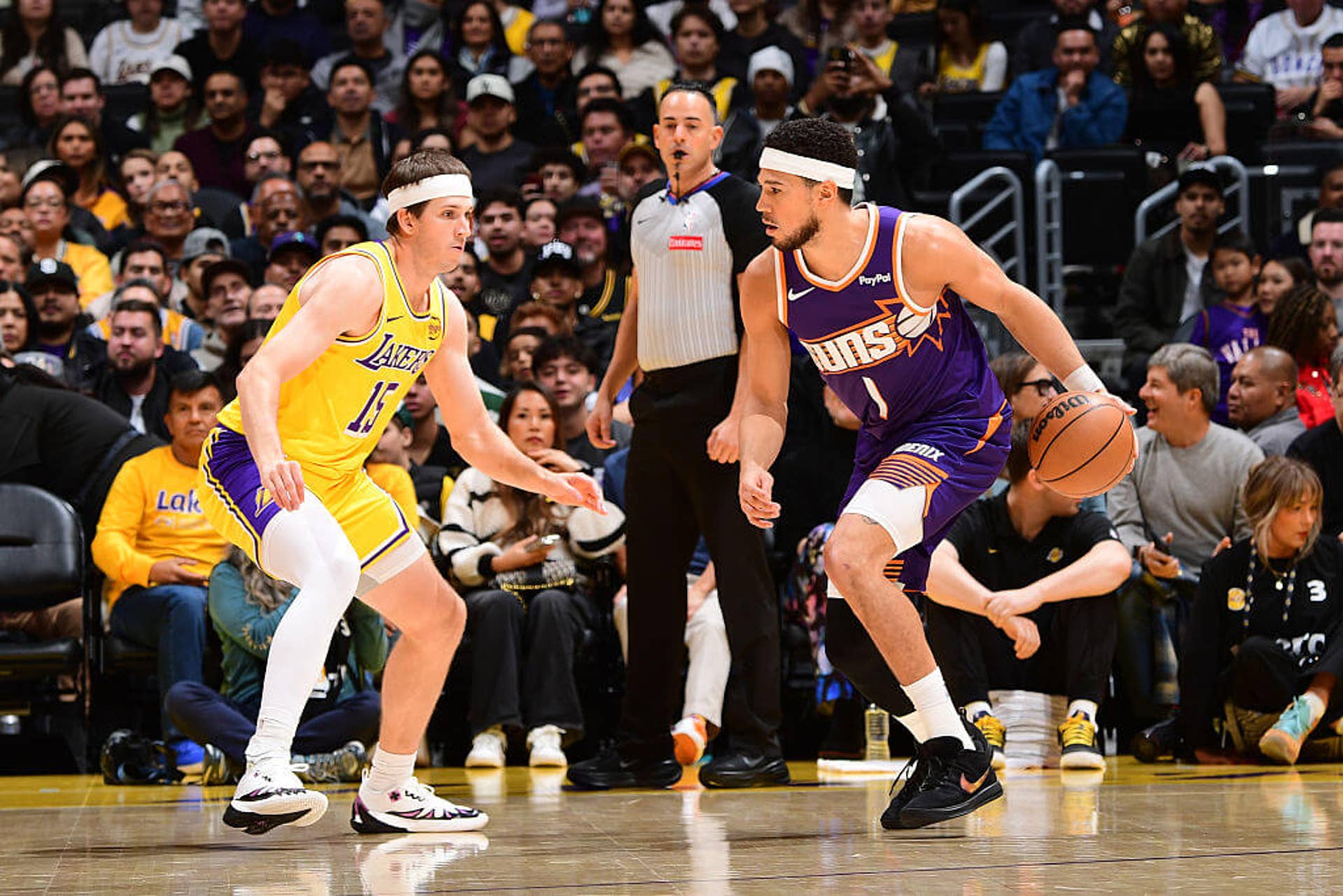 Devin Booker attempts to dribble past Austin Reaves.