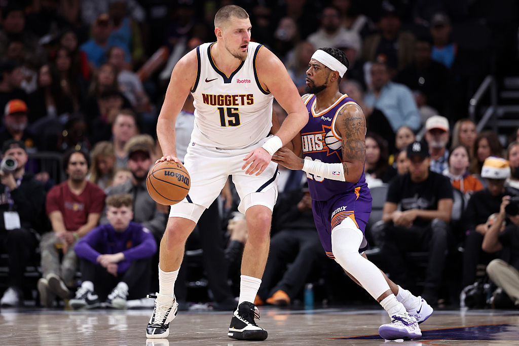 PHOENIX, ARIZONA - NOVEMBER 29: Nikola Jokic #15 of the Denver Nuggets posts up on Jordan Goodwin #23 of the Phoenix Suns during the second half at Mortgage Matchup Center on November 29, 2025 in Phoenix, Arizona. NOTE TO USER: User expressly acknowledges and agrees that, by downloading and or using this photograph, User is consenting to the terms and conditions of the Getty Images License Agreement. (Photo by Chris Coduto/Getty Images)