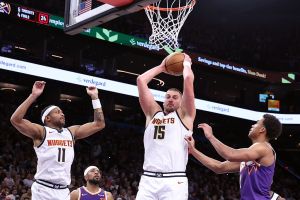 PHOENIX, ARIZONA - NOVEMBER 29: Nikola Jokic #15 of the Denver Nuggets controls a rebound against Oso Ighodaro #11 of the Phoenix Suns during the second half at Mortgage Matchup Center on November 29, 2025 in Phoenix, Arizona. The Nuggets defeated the Suns 130-112. NOTE TO USER: User expressly acknowledges and agrees that, by downloading and or using this photograph, User is consenting to the terms and conditions of the Getty Images License Agreement. (Photo by Chris Coduto/Getty Images)