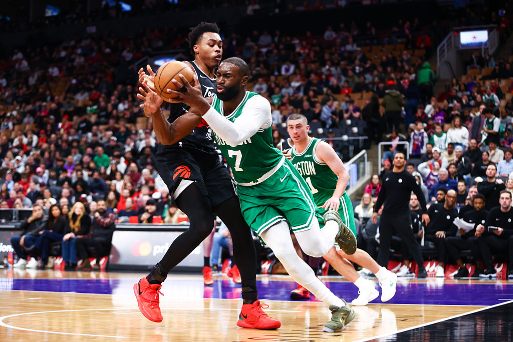 TORONTO, CANADA - DECEMBER 07: Jaylen Brown #7 of the Boston Celtics tries to play the ball as he's defended by Scottie Barnes #4 of the Toronto Raptors during the second half of their NBA game at Scotiabank Arena on December 7, 2025 in Toronto, Ontario, Canada. NOTE TO USER: User expressly acknowledges and agrees that, by downloading and/or using this Photograph, user is consenting to the terms and conditions of the Getty Images License Agreement (Photo by Cole Burston/Getty Images)