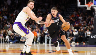Grayson Allen #8 of the Phoenix Suns drives as Luka Doncic #77 of the Los Angeles Lakers defends du...