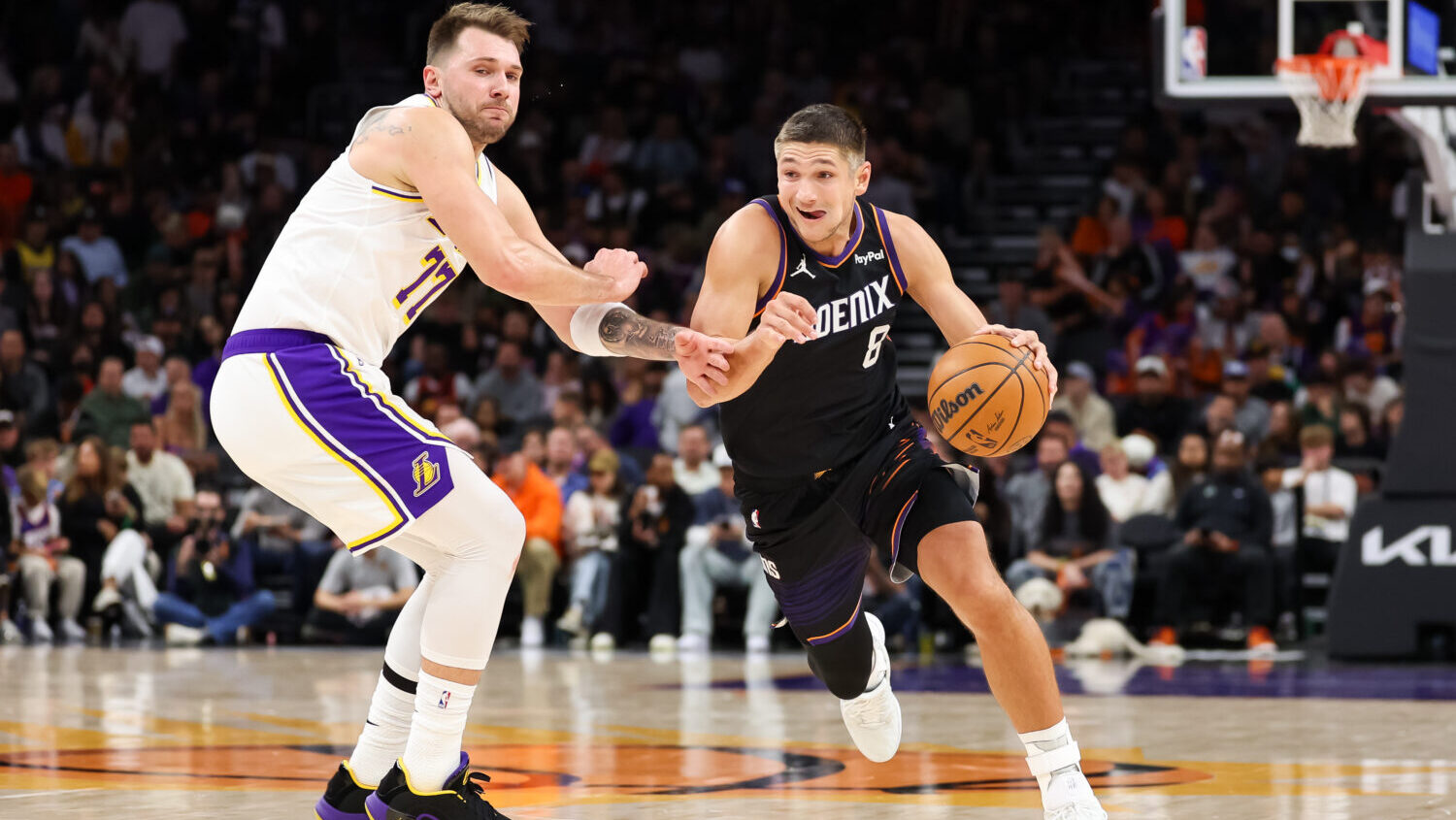 Grayson Allen #8 of the Phoenix Suns drives as Luka Doncic #77 of the Los Angeles Lakers defends du...