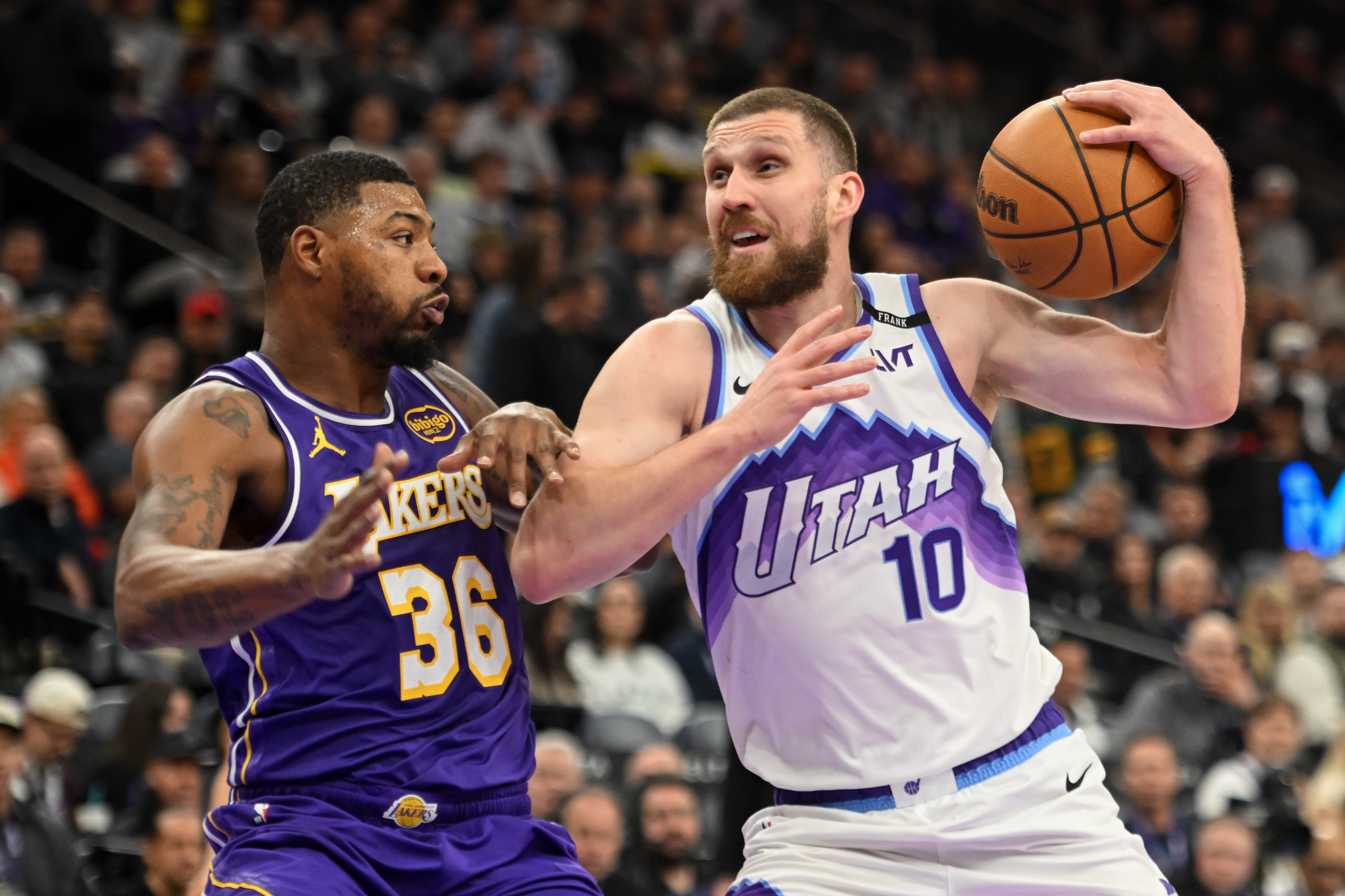 The Utah Jazz’s Svi Mykhailiuk, right, drives as Lakers guard...