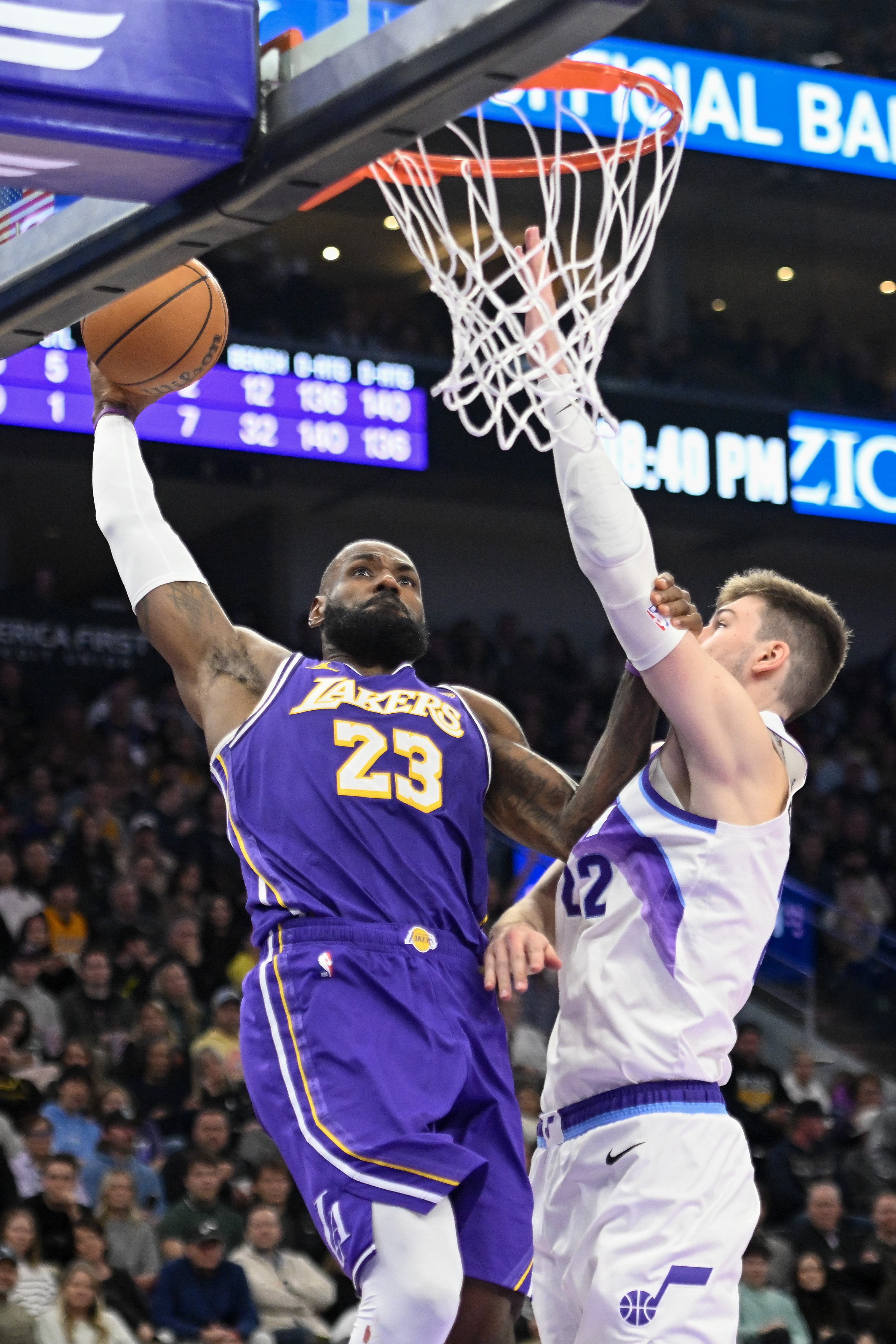 Lakers star LeBron James dunks over Utah Jazz forward Kyle...
