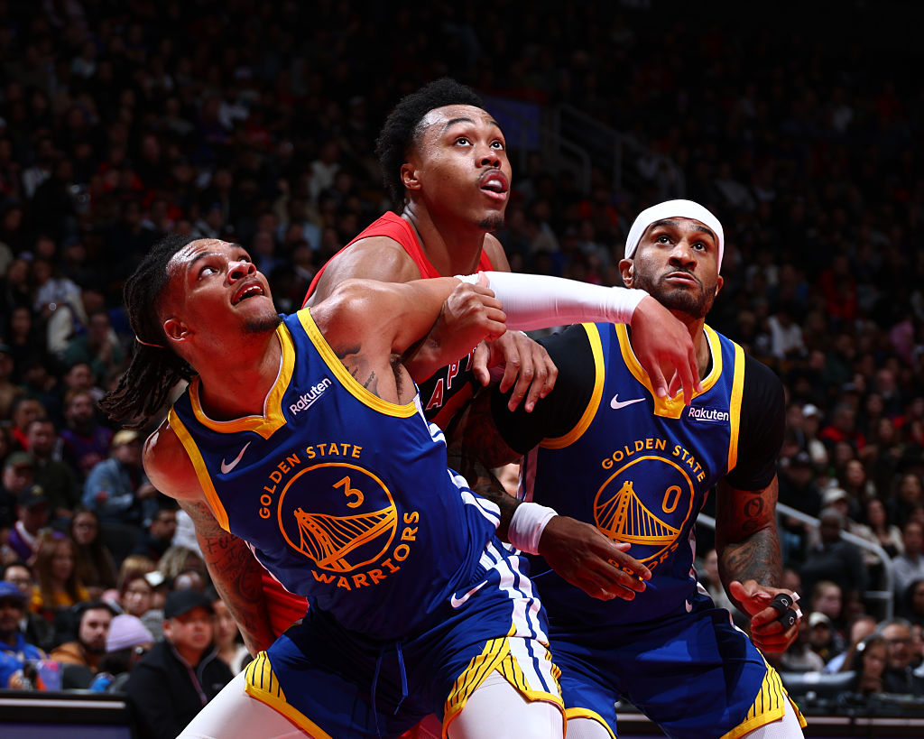 TORONTO, CANADA - DECEMBER 28: Will Richard #3 and Gary Payton II #0 of the Golden State Warriors box out Scottie Barnes #4 of the Toronto Raptors during the game on December 28, 2025 at the Scotiabank Arena in Toronto, Ontario, Canada.