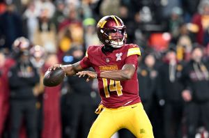LANDOVER, MARYLAND - DECEMBER 20: Josh Johnson #14 of the Washington Commanders throws a pass against the Philadelphia Eagles at Northwest Stadium on December 20, 2025 in Landover, Maryland. (Photo by G Fiume/Getty Images)