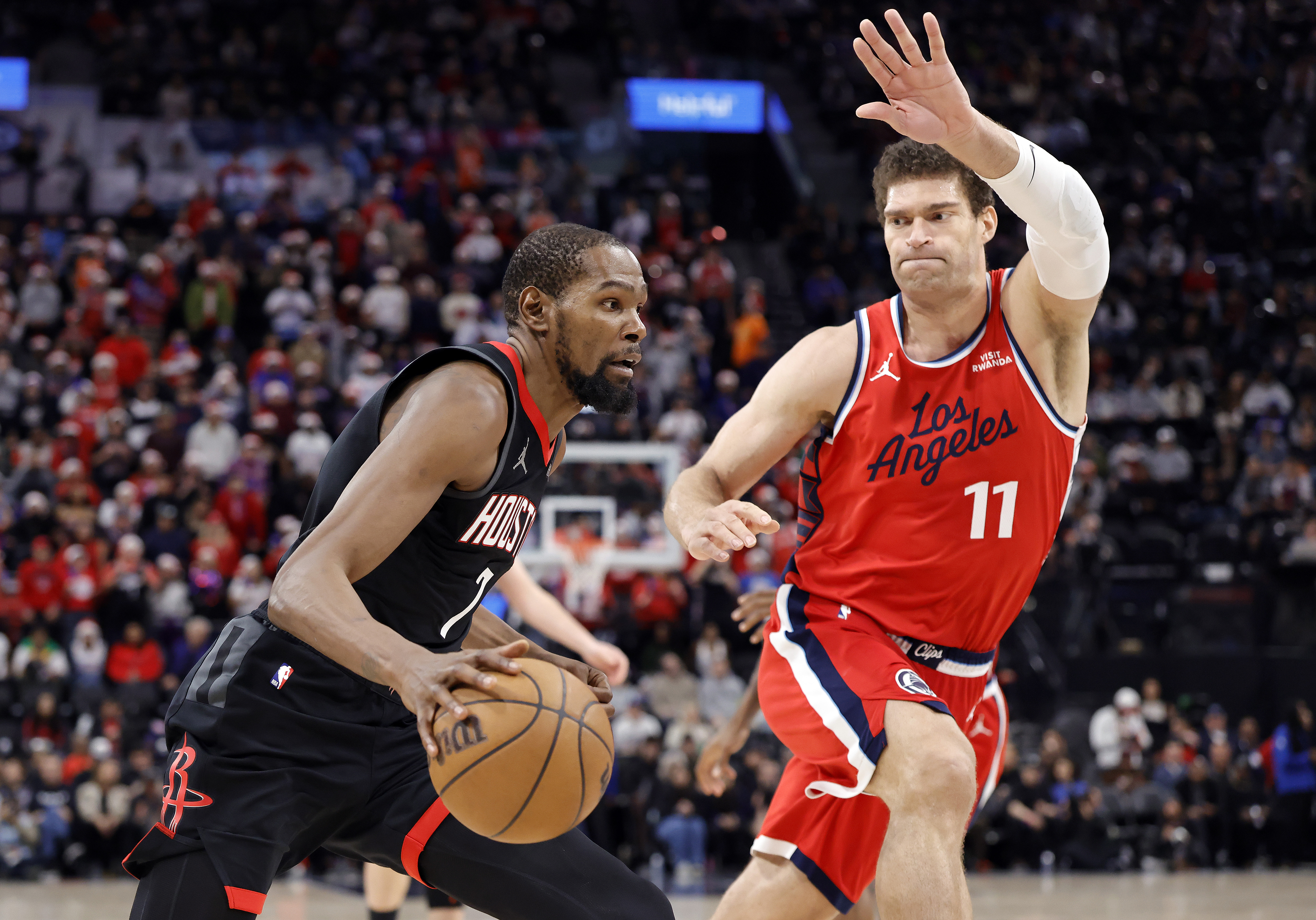 Houston Rockets star Kevin Durant drives as Clippers center Brook...