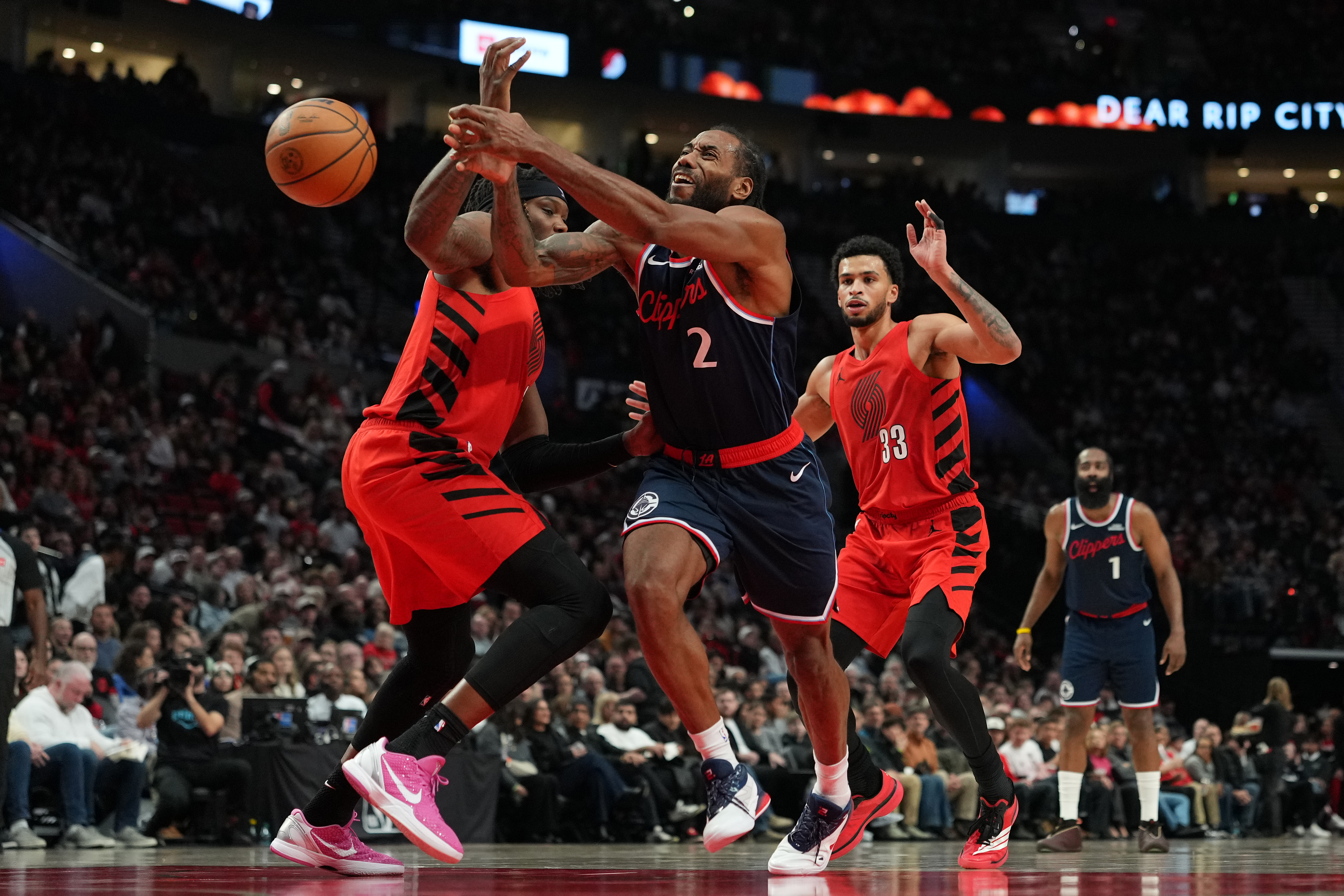 Clippers star Kawhi Leonard (2) is fouled by Portland Trail...