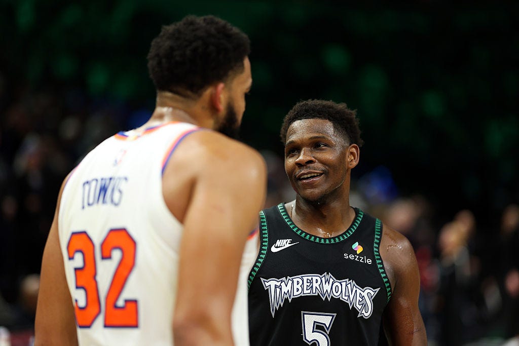 Anthony Edwards #5 of the Minnesota Timberwolves and Karl-Anthony Towns #32 of the New York Knicks interact after the game at Target Center on December 23, 2025 in Minneapolis, Minnesota. The Timberwolves defeated the Knicks 115-104.