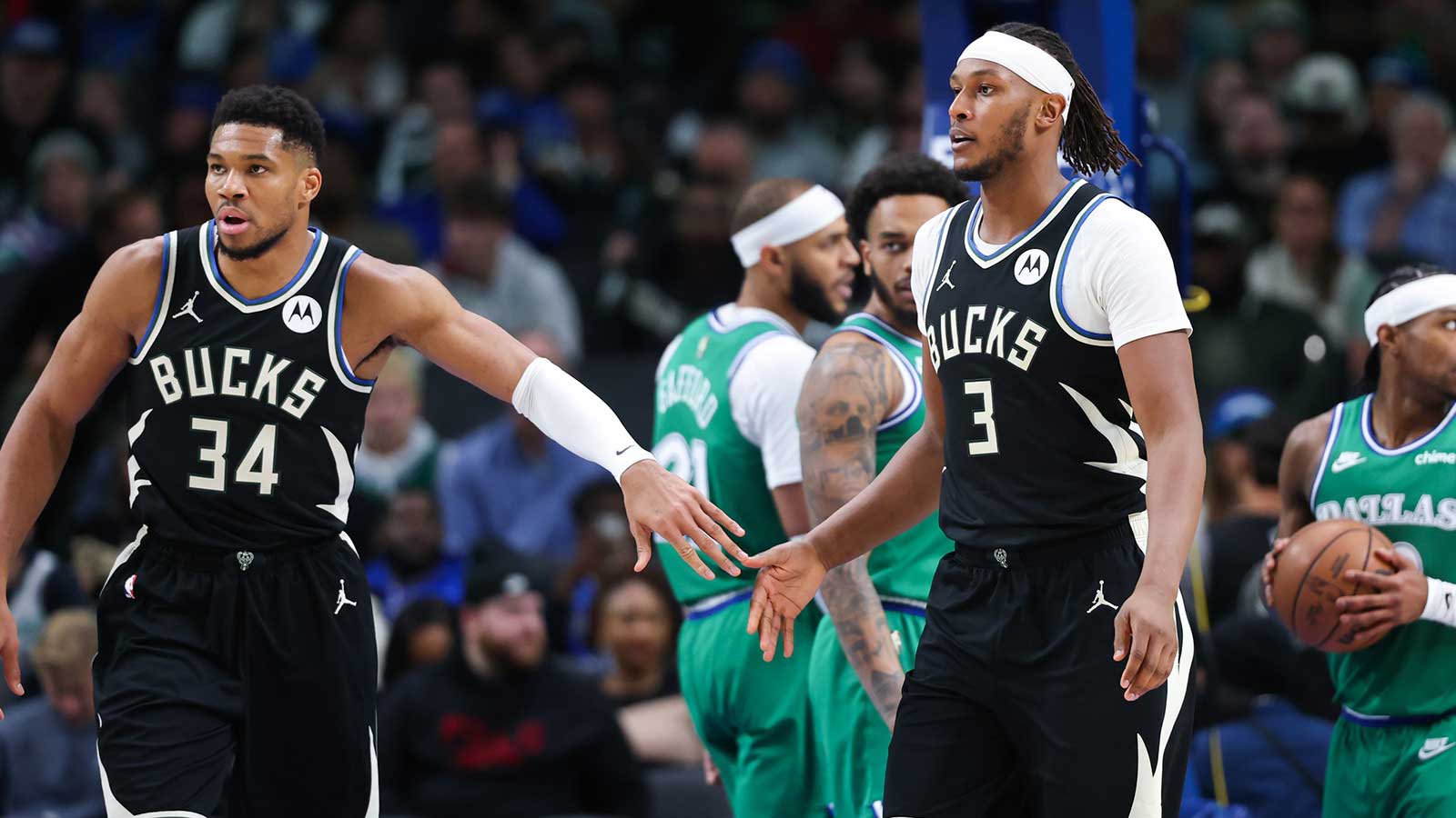 Milwaukee Bucks forward Giannis Antetokounmpo (34) celebrates with Milwaukee Bucks center Myles Turner (3) during the third quarter against the Dallas Mavericks at American Airlines Center.