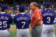 Texas Rangers owner Tom Hicks, second right, and players Rafael Palmeiro, Ivan Rodriguez,...