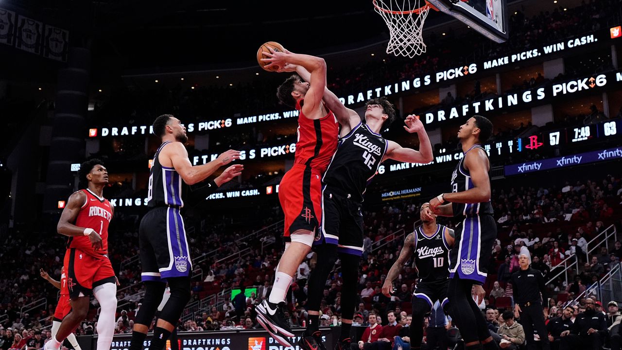 Houston Rockets center Alperen Sengun (28) shoots against Sacramento Kings center Maxime Raynaud (42) during the second half of an NBA basketball game in Houston, Wednesday, Dec. 3, 2025. (AP Photo/Ashley Landis)