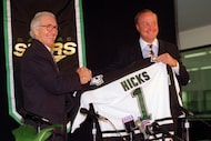 Norm Green (left) shakes hands with new Dallas Stars owner Thomas O. Hicks at a news...