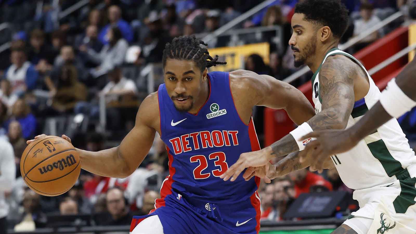 Detroit Pistons guard Jaden Ivey (23) defended by defended by Milwaukee Bucks guard Gary Harris (11) in the second half at Little Caesars Arena.