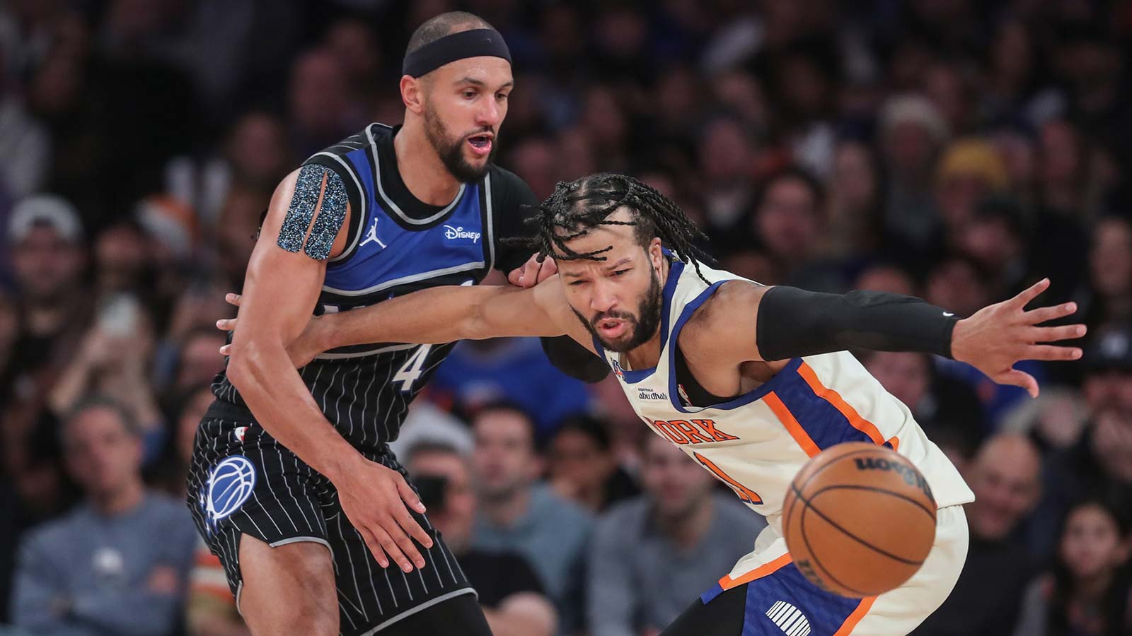 Orlando Magic guard Jalen Suggs (4) knocks the ball away from New York Knicks guard Jalen Brunson (11) in the fourth quarter at Madison Square Garden. Mandatory Credit: Wendell Cruz-Imagn Images