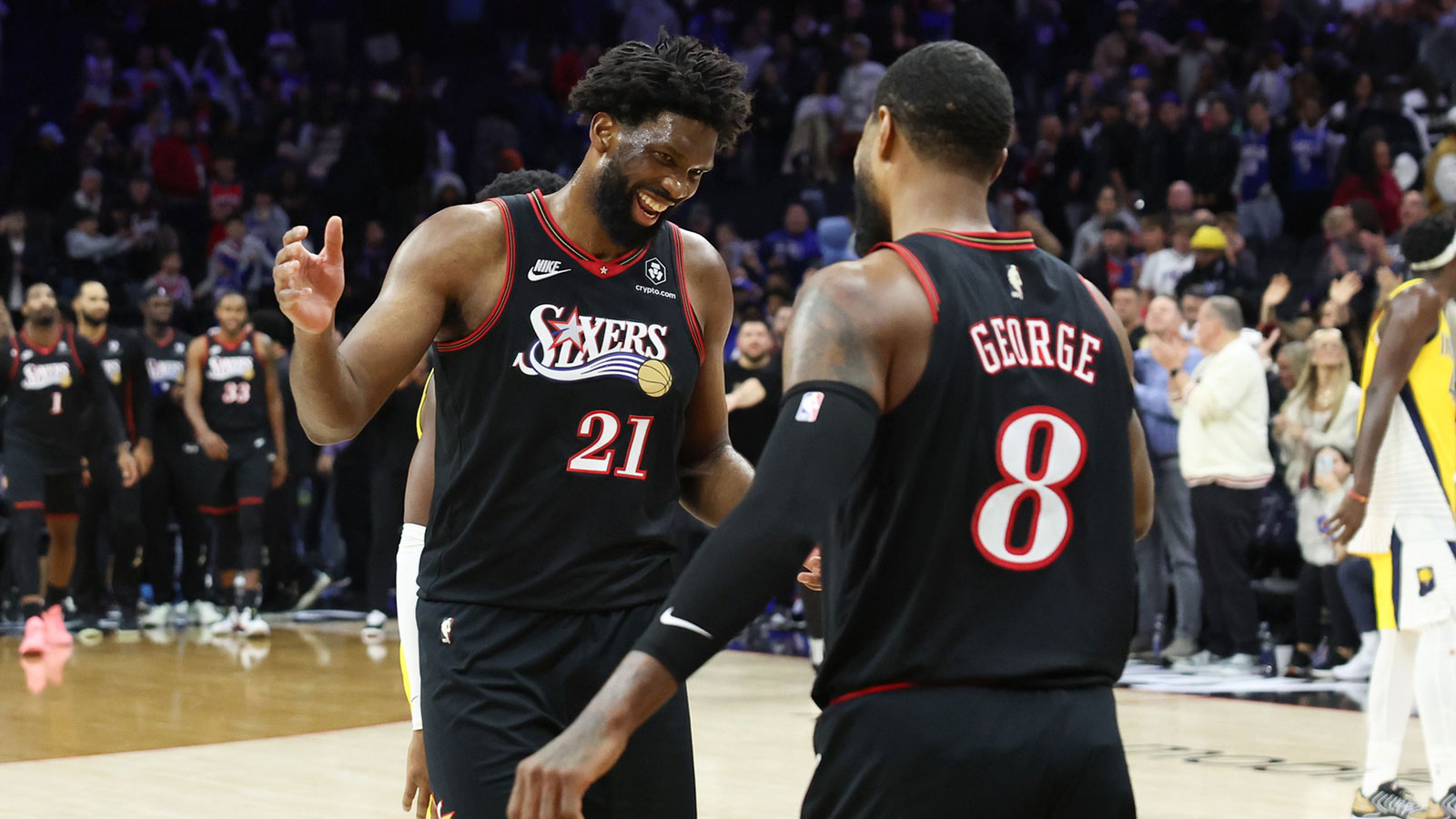 Philadelphia 76ers center Joel Embiid (21) reacts with forward Paul George (8) after a victoryagainst the Indiana Pacers during at Xfinity Mobile Arena. 