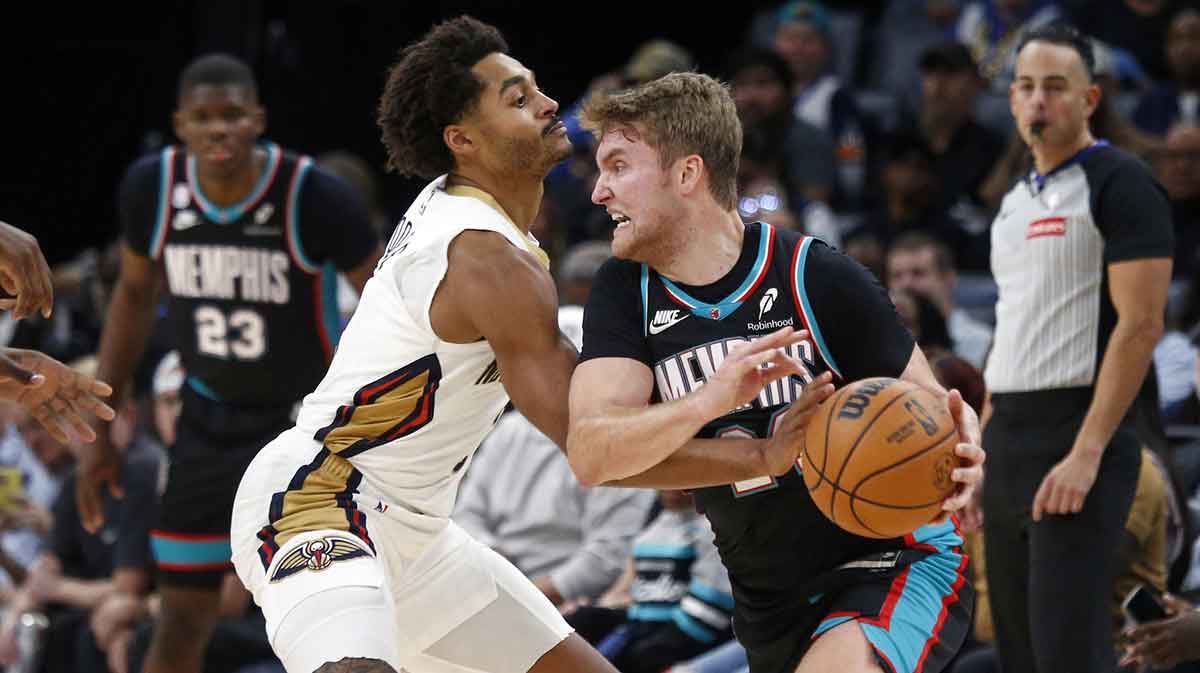Oct 22, 2025; Memphis, Tennessee, USA; Memphis Grizzlies guard Cam Spencer (24) handles the ball as New Orleans Pelicans guard Jordan Poole (3) defends during the fourth quarter at FedExForum. Mandatory Credit: Petre Thomas-Imagn Images