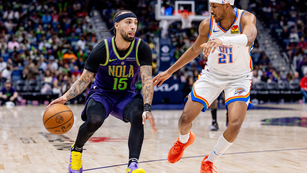 New Orleans Pelicans guard Jose Alvarado (15) dribbles against Oklahoma City Thunder guard Aaron Wiggins (21) during the second half at Smoothie King Center.