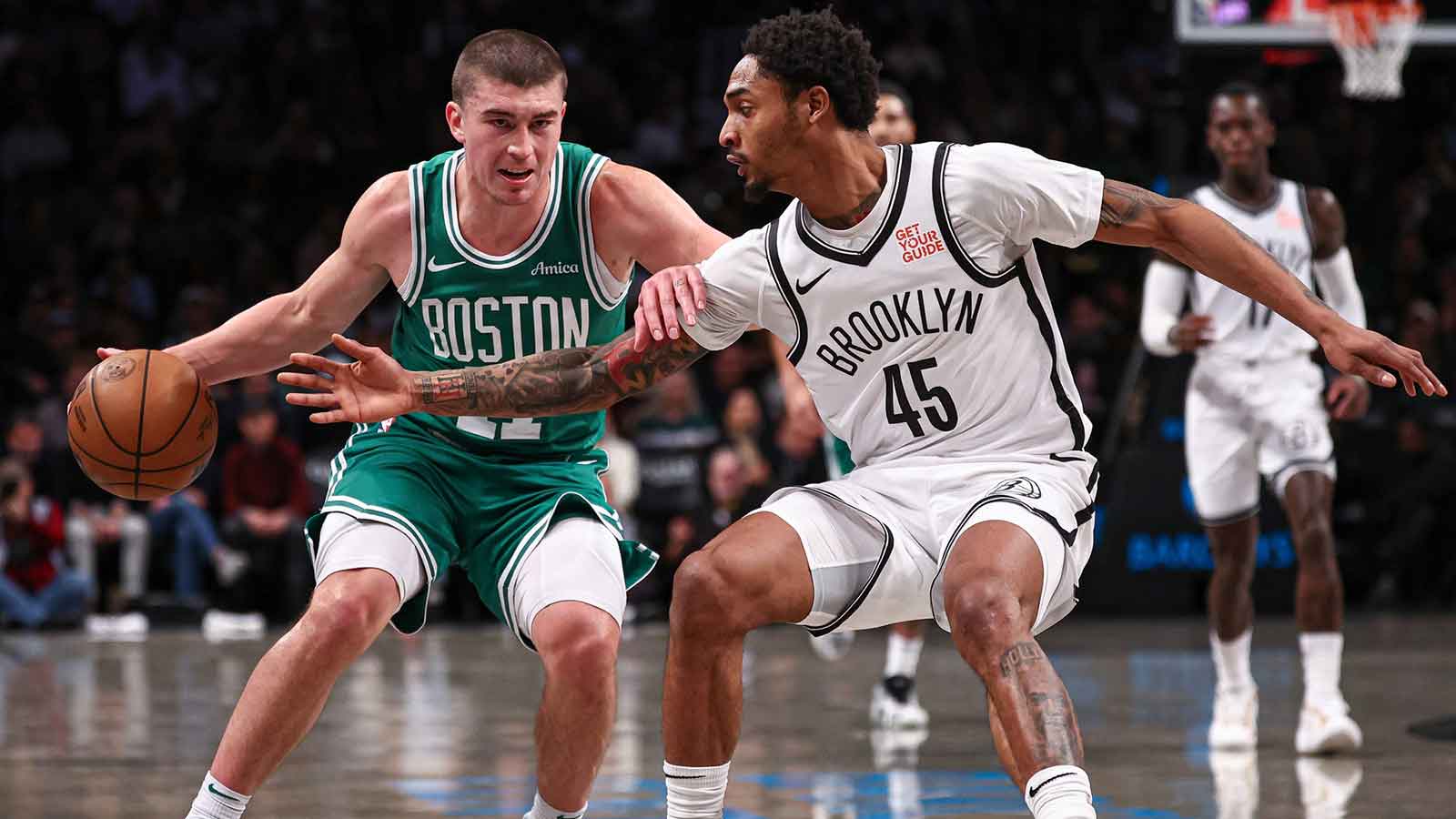 Boston Celtics guard Payton Pritchard (11) dribbles as Brooklyn Nets guard Keon Johnson (45) defends during the first half at Barclays Center.