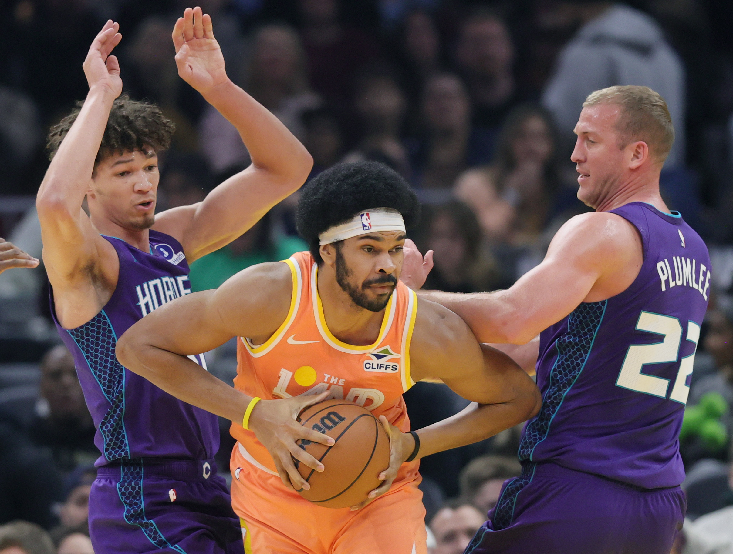 Cleveland Cavaliers center Jarrett Allen (C) looks to make a pass in the defense of Charlotte Hornets forward Tidjane Salaun (L) and Charlotte Hornets center Mason Plumlee in the first half at Rocket Arena. 