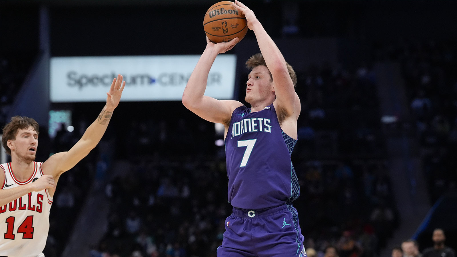 Charlotte Hornets guard Kon Knueppel (7) shoots a three-pointer against Chicago Bulls forward Matas Buzelis (14) during the second quarter at Spectrum Center.
