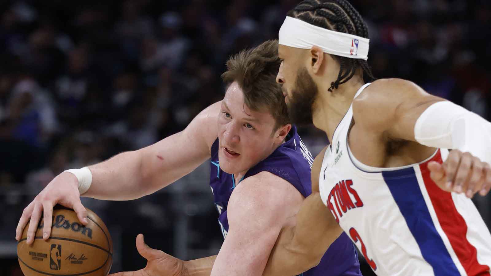 Charlotte Hornets guard Kon Knueppel (7) is defended by Detroit Pistons guard Cade Cunningham (2) in the second half at Little Caesars Arena.