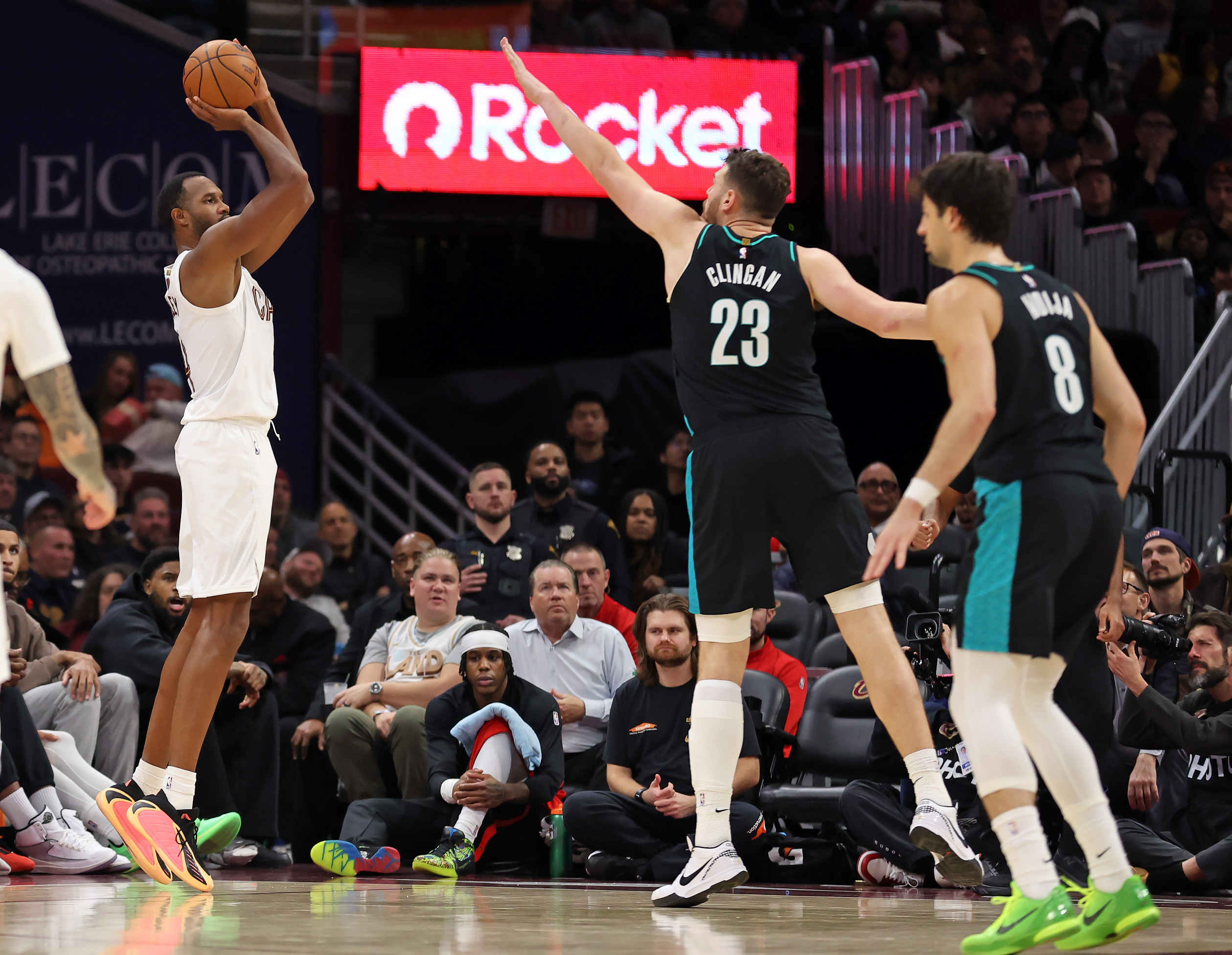 Cleveland Cavaliers center Evan Mobley shoots a three over Portland Trail Blazers center Donovan Clinganin the second half of play. 