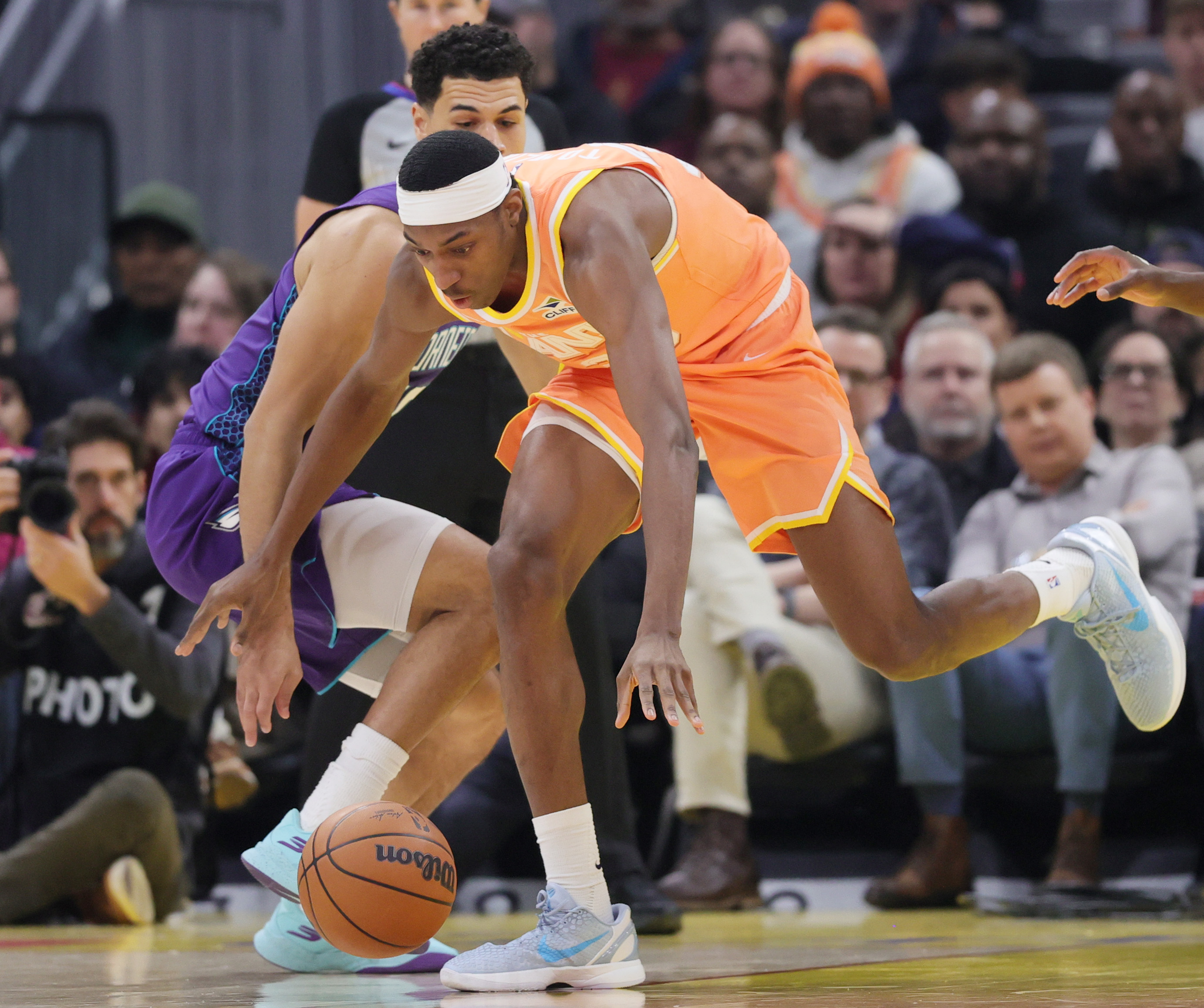 Cleveland Cavaliers forward Nae'Qwan Tomlin retrieves a loose ball knocked from his hands by Charlotte Hornets guard Josh Green in the first half at Rocket Arena. 