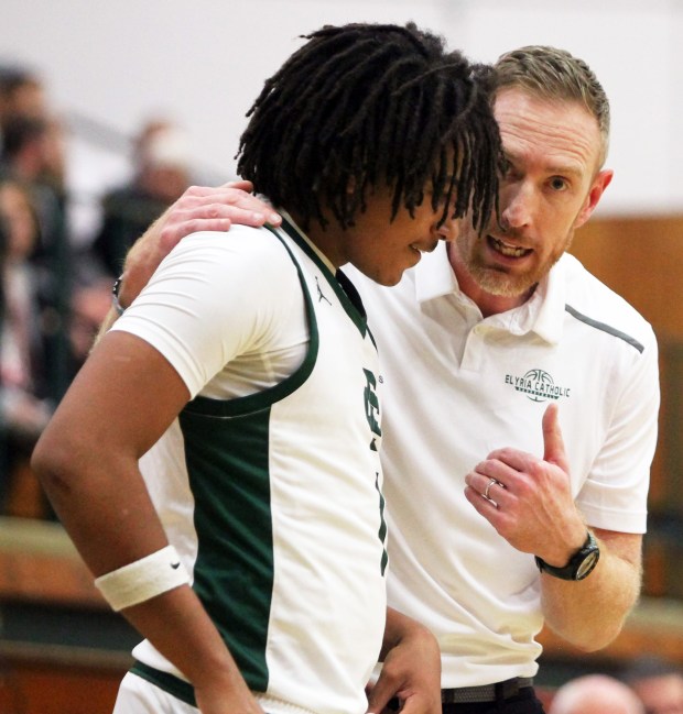 Elyria Catholic coach Jason Smith speaks to Jazear Terry during a time out on Dec. 5. (Randy Meyers - for The Morning Journal)