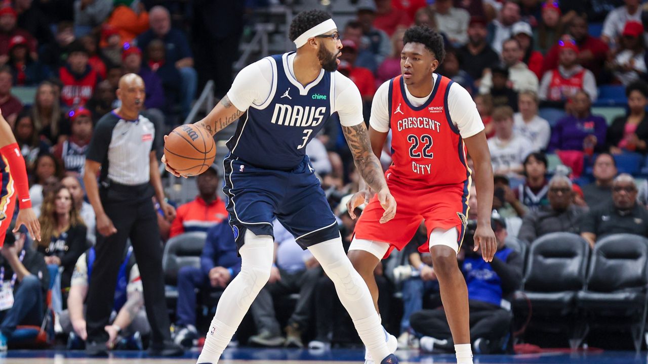 Dallas Mavericks forward Anthony Davis (3) tries to make a move against New Orleans Pelicans center Derik Queen (22) in the first half of an NBA basketball game Monday, Dec. 22, 2025, in New Orleans. (AP Photo/Peter Forest)