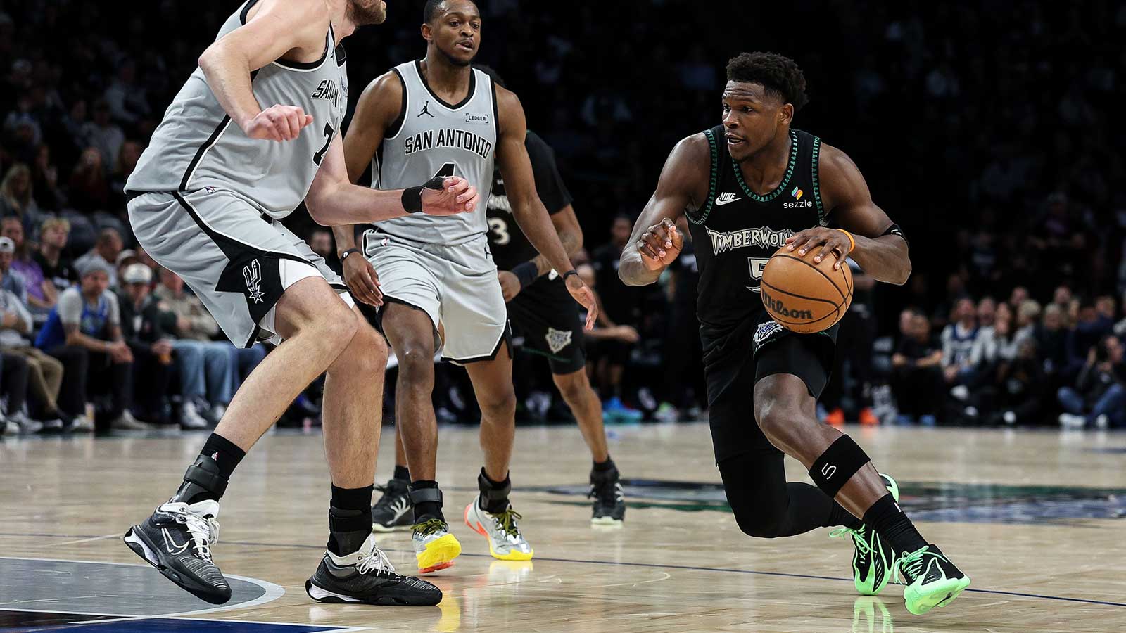 Minnesota Timberwolves guard Anthony Edwards (5) drives towards the basket as San Antonio Spurs center Luke Kornet (7) defends during the second half at Target Center.