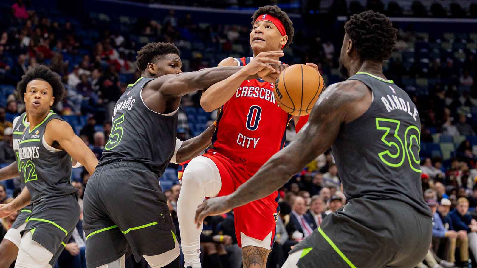 Minnesota Timberwolves guard Anthony Edwards (5) blocks the lay up attempt of New Orleans Pelicans guard Jeremiah Fears (0) during the first half at Smoothie King Center.